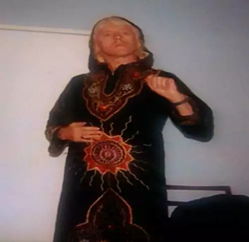 Jimmy Savile wearing a robe with an 11 pointed star which decorates the front